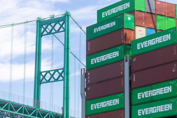 Containers stacked next to Vincent Thomas Bridge at Port of Los Angeles.