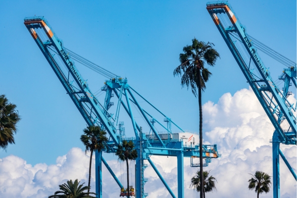 APM Terminal cranes agains fluffy clouds at the Port of Los Angeles.